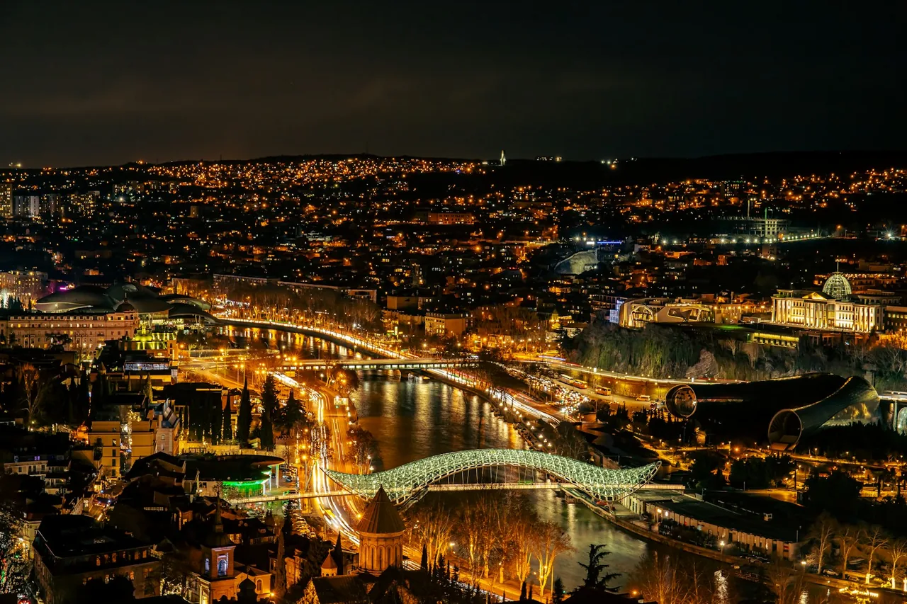 Tbilisi at night seen from above, with the river and its bridges